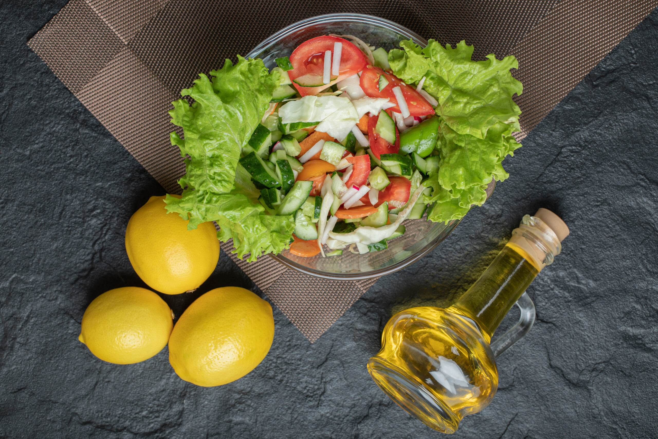 Homemade mixed salad on table for lunch on black background. High quality photo